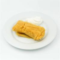 Tamal de Elote · Sweet corn cake served with sour cream.