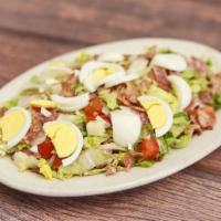 Chopped Salad · Mixed lettuce, salami, cheese, tomatoes, bacon and hard boiled eggs. Served with garlic bread.