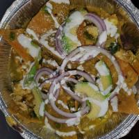 Chilaquiles Verdes · Crispy corn tortilla chips, covered in green tomatillo sauce, red onions, avocado slice, sou...