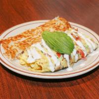 California Omelette · Bacon, mushroom, green onions, tomatoes, jack and cheddar topped with sour cream and avocado...