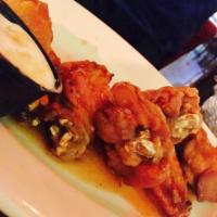 Buffalo Wings · 8 jumbo wings tossed in buffalo sauce with a blue cheese dipping sauce.