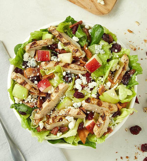 Chicken Harvest Entree Salad · Chicken breast, hardwood smoked bacon, bleu cheese, crisp apples, honey roasted pecans and dried cranberries. Served with apple cider vinaigrette.