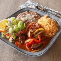57. Steak Picado Platillo · Steak marinated with onion, bell pepper, tomato and sauce.
Rice,beans,salad & tortillas