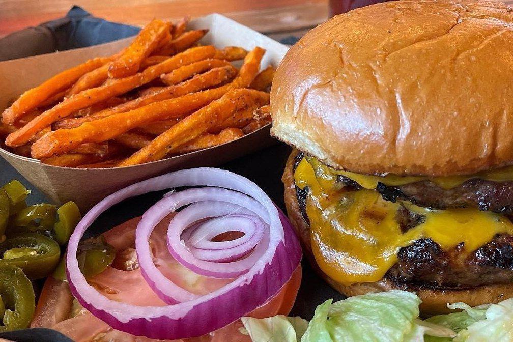 The OG Burger · Our burgers are house-ground and pressed using our Prime-grade brisket which makes them better than a regular burger. Includes your choice of side. All toppings will come on the side.