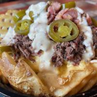 Freedom Fries · Waffle fries topped with mac-n-cheese, brisket, sausage, jalapenos and jalapeno ranch dressi...
