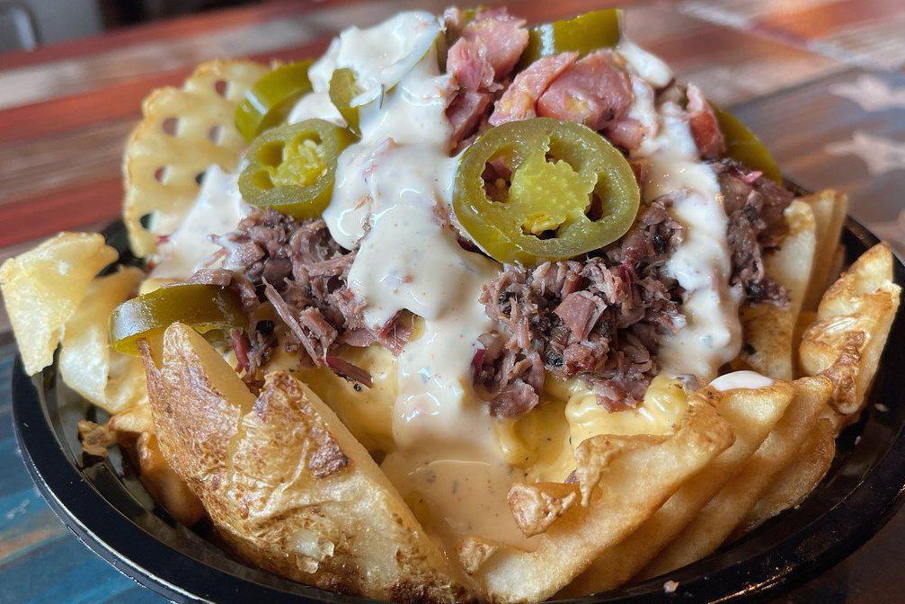 Freedom Fries · Waffle fries topped with mac-n-cheese, brisket, sausage, jalapenos and jalapeno ranch dressing. (All toppings will come on the side so the fries don’t get soggy.)