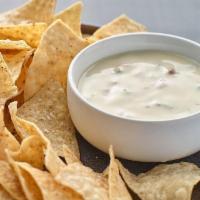 Chips ＆ Queso · 16 oz of melted queso blanco with a blend of hatch chiles, poblano and jalapeno peppers resu...