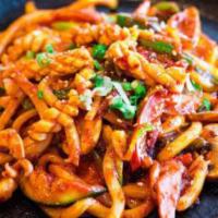 Chulpan Ojinguh Bokkeum · Stir fried squid and vegetables with choice of udon noodle or rice cakes. Served on a hotpla...