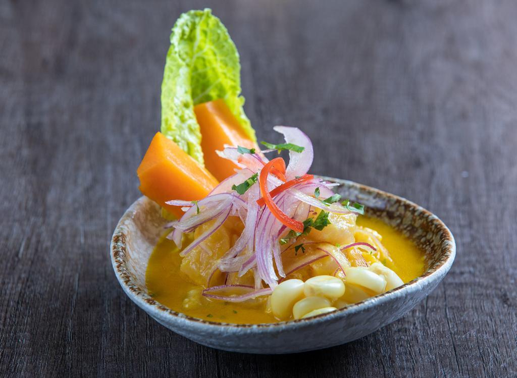 Yellow Pepper Ceviche · Fish and seafood marinated in lime juice, with onion and a yellow, pepper sauce, served with sweet potato and 'choclo'.