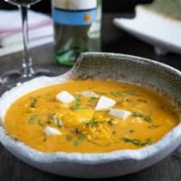 Chupe de Camarones · Shrimp flambé with pisco and white wine, with coral sauce, Peruvian spices, egg, cheese and ...