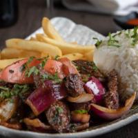 'Lomo Saltado' · Beef tenderloins sauté in a wok with onion, tomato, soy sauce, rice and French fries. 