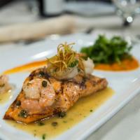 Mancora Salmon · Grilled fresh salmon fillet with capers sauce, lime juice, topped with shrimp,  on a bed of ...