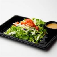 House Salad · Spring mix, tomato, and ginger dressing.