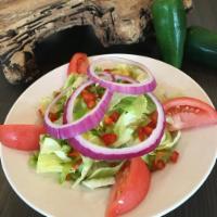 House Salad · Iceberg and romaine with cheddar cheese, tomato, cucumber, red onion, and croutons. Served w...