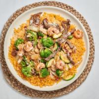 Peluza  · Steak, shrimp, chicken, broccoli, onions, bell peppers and zucchini on a bed of rice topped ...