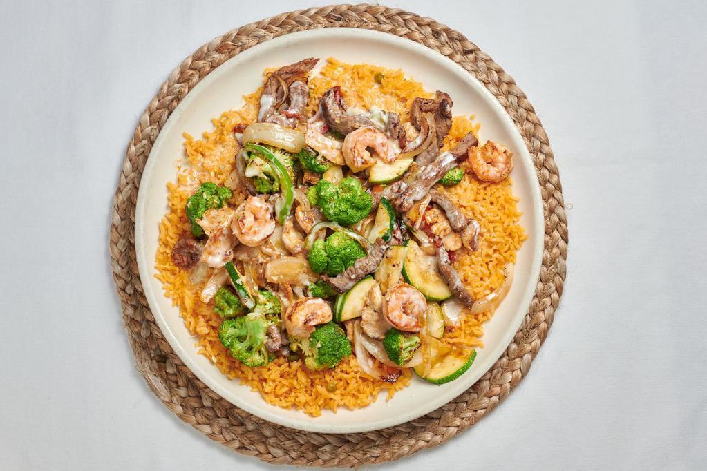 Peluza  · Steak, shrimp, chicken, broccoli, onions, bell peppers and zucchini on a bed of rice topped with queso sauce. 