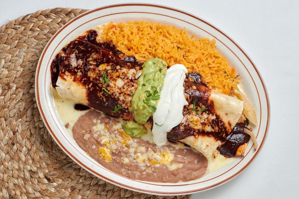 Burrito California · Flour tortilla filled with grilled chicken, grilled onions, and cheese, and then topped with our family recipe mole and cheese dip. Side of guacamole and sour cream. Served with rice and beans.