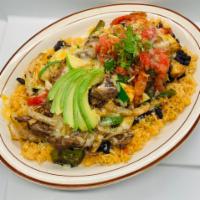Steak Carnaval · Grilled shredded steak, grilled onions, bell peppers, squash, and mushrooms on a bed of rice...