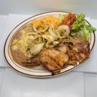 Chuletas a la Parrilla · Grilled pork chops seasoned with our signature spices and topped with onions. Served with ri...