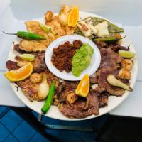 Fiesta Molcajete · Choice of guacamole or cheese dip, served with chorizo, pork chops, steak, chicken, shrimp, ...