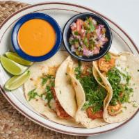 Shrimp Tacos · 3 soft tacos filled with seasoned shrimp. Topped with onions, cilantro. Served with spicy ch...