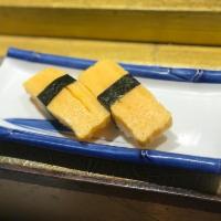 Tamago Nigiri (2 PCS) · Tamago sushi is made with the rolled egg omelet (tamagoyaki) and seasoned sushi rice. It's u...