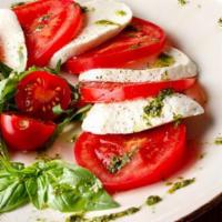 Caprese Salad · Tomatoes, basil, fresh mozzarella with pesto.