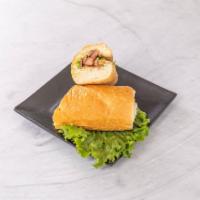 20. Vietnamese Sandwich · Sliced pork marinated in a lemon-grass soy dressing, cucumber, pickled carrots and daikon, c...