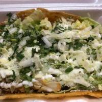 Huaraches con Carne · Large Homemade fresh oval corn tortilla layered with refried beans, cilantro, onions, lettuc...