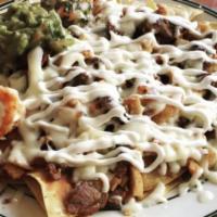Nachos Supreme · Chicken, steak and shrimp; Tortilla chips with melted cheese and refried beans, topped with ...