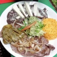 Cecina Asada con Nopales · Grilled salted thin steak with cactus. Served with rice, beans and tortillas or your choice ...