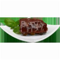 BBQ Pork Ribs · Slow cooked  juicy pork ribs slathered in our delicious bbq sauce. 