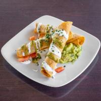 Lobster and Shrimp Taquitos · Salsa verde, lime cream, tomato, guacamole and chives.