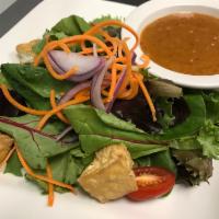 House Salad · Mixed green, fried tofu, onion, tomato with Thai peanut dressing.
