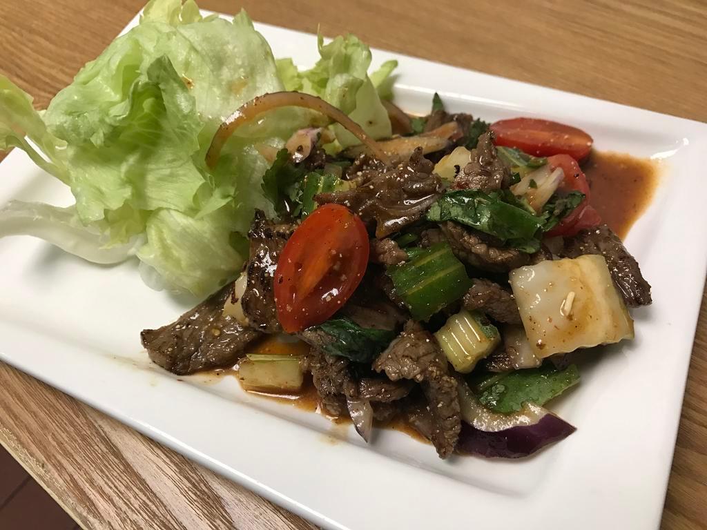 Steak Salad · Grilled marinated frank steak, onion, tomato, chili cucumber, toasted rice powder, lime, fish sauce, lime dressing served with lettuce . Medium spicy.