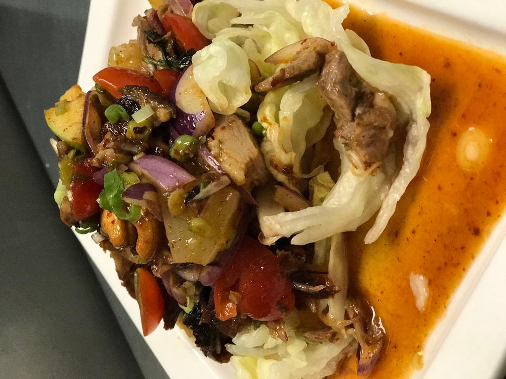 Crispy Duck Salad · Crispy roasted duck, onion, tomato, pineapple, green apple, cashew nut, roasted chili, fish sauce and lime dressing served with lettuce . Medium spicy.