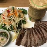 Tiger Cry Steak · Marinated flank steak served with papaya salad and sticky rice