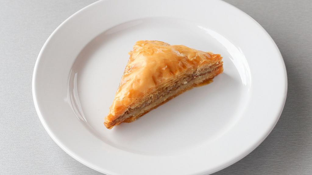 Baklava Triangle (1pc) · Layers of honey glazed crispy phyllo pastry filled with crushed nuts and honey.