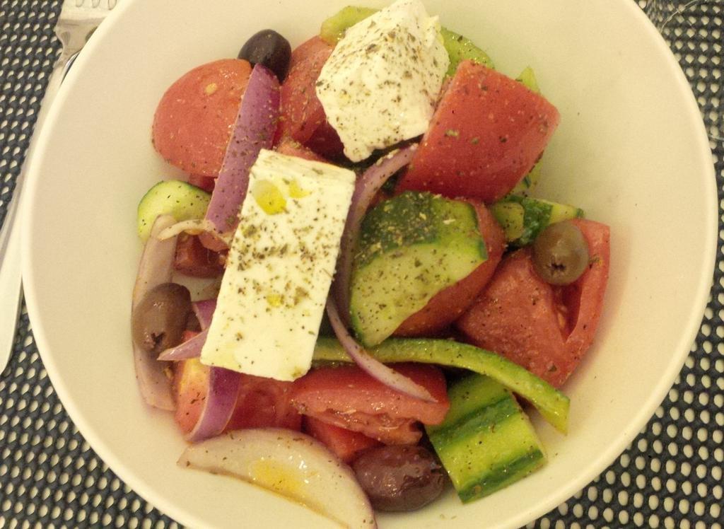 Horiatiki Salad · Classic Greek Salad with Tomatoes, Cucumbers, Peppers, Onions, Kalamata Olives, Feta and Extra Virgin Olive Oil.