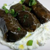 Dolmades · Grape leaves stuffed with rice, Greek Herbs and extra virgin olive oil.
