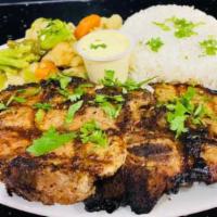 Pork Chops · Two center cut pork chops marinated and charboiled.