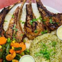 Grilled Cordero (Lamb) · Four lamb chops marinated and chargrilled.