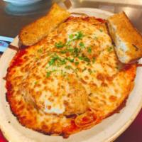 Chicken Parmesan · 2 breaded chicken breasts baked with homemade marinara sauce and topped with mozzarella and ...