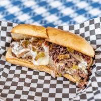 Prime Rib Philly Sandwich · Slowly smoked and thinly sliced prime rib cooked with onions and green chilies served on a t...
