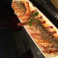 Crunchy Shrimp Roll · Shrimp tempura, avocado and cream cheese inside. Topped with tempura flakes, eel sauce.