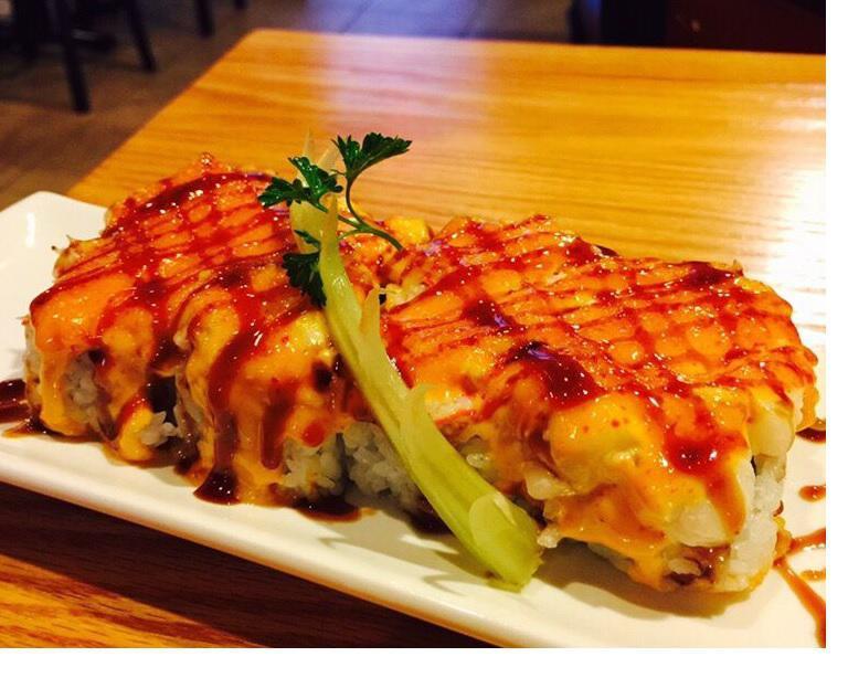 Baked Scallop Roll · Crab mixed, avocado, cream cheese inside. Topped with baked scallop, spicy mayo, eel sauce.