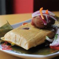 Tamales Amarillo · White corn tamale made with pork or chicken, dried black olives, Peruvian chili peppers and ...