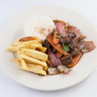 Lomo Saltado de Carne · A popular Peruvian dish of succulent beef tenderloin sauteed to perfection with red onions a...