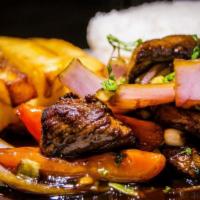 Saltado de Pollo · Sliced chicken breast sauteed with bell peppers, carrots, snow peas, red onions and tomatoes...