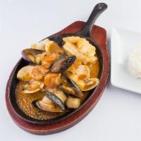 Pescado a lo Macho · Grilled or fried fish with a seafood cream, scallops, shrimp and squid based white wine sauc...